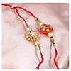 Orange round kundan stone with beads rakhi with flower rakhi