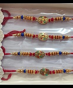 Oval design rakhi with red and blue beads and chawal chandan tika pack